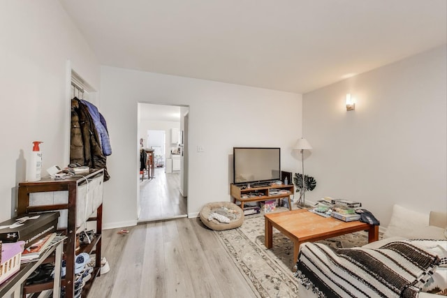 living room featuring wood finished floors and baseboards