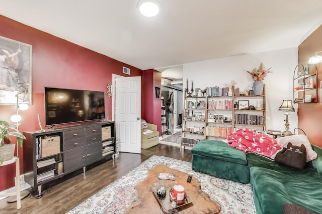 living area with visible vents and wood finished floors