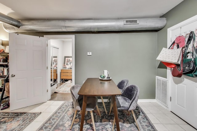 dining space with light tile patterned flooring and visible vents