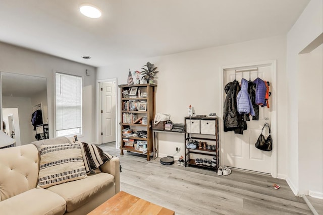 living area featuring baseboards and wood finished floors