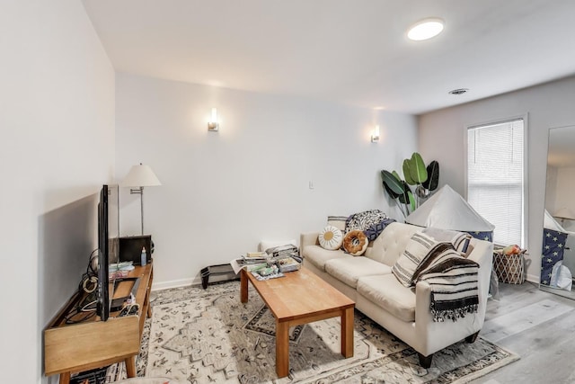 living room with light wood finished floors and baseboards