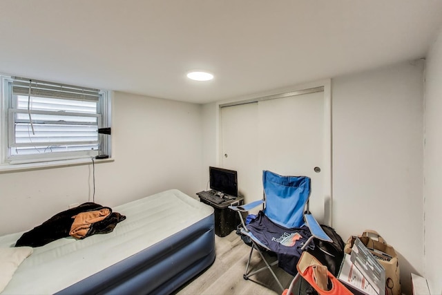 bedroom featuring a closet and light wood-type flooring