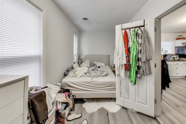 bedroom with visible vents and light wood-type flooring