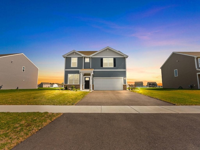 view of front of house with brick siding, an attached garage, aphalt driveway, and a lawn