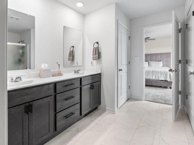 bathroom featuring connected bathroom, marble finish floor, a sink, and visible vents
