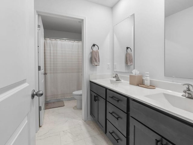 full bath featuring double vanity, marble finish floor, a sink, and toilet