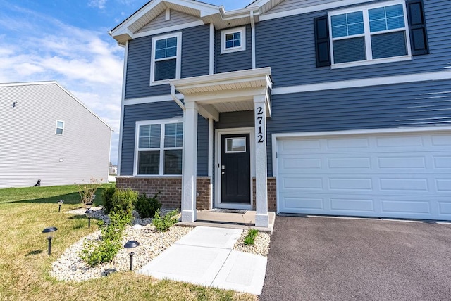 view of front of property featuring brick siding and driveway