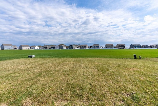 surrounding community with a residential view and a lawn