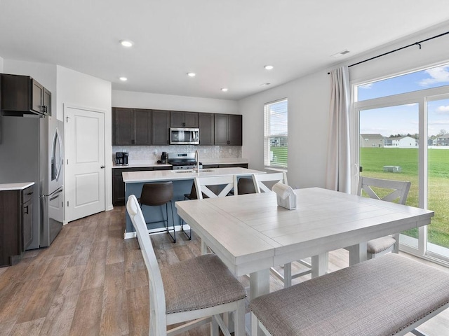 dining room with recessed lighting and light wood-type flooring
