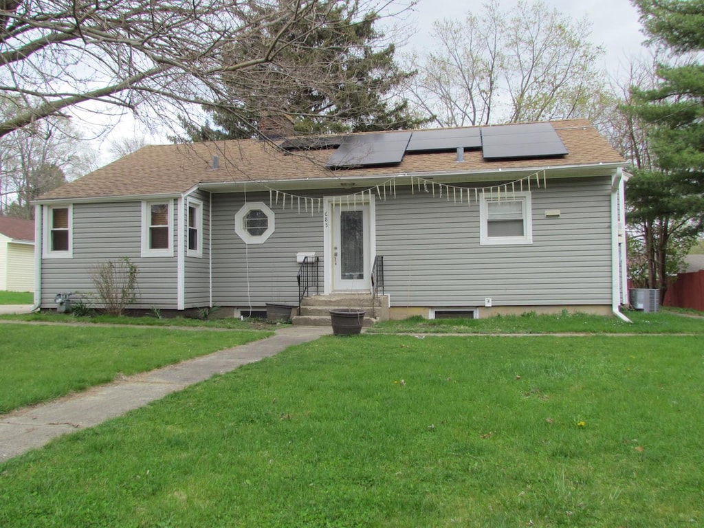685 Wood St, Aurora, IL 60505 - view of front of house with a front lawn, solar panels, and cooling unit
