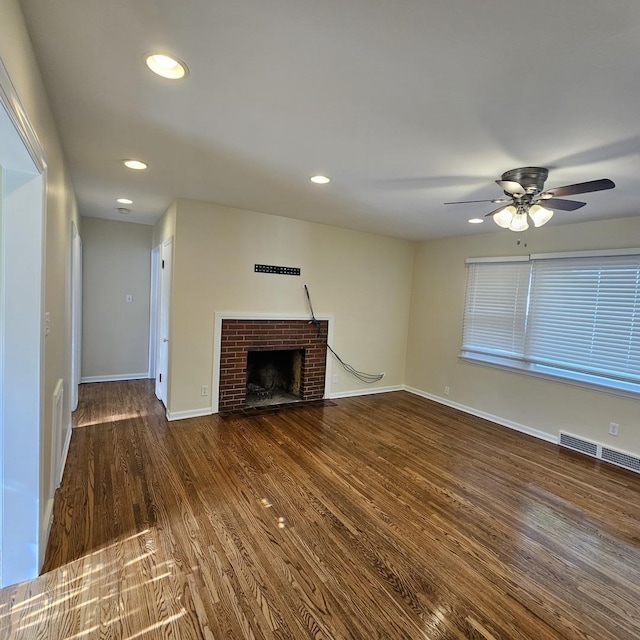 unfurnished living room featuring wood finished floors, a ceiling fan, a fireplace, recessed lighting, and baseboards