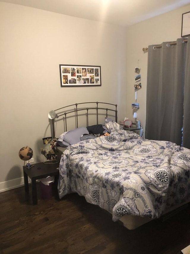 1941 W Roscoe St, Chicago, IL 60657 - bedroom featuring baseboards and dark wood-style flooring