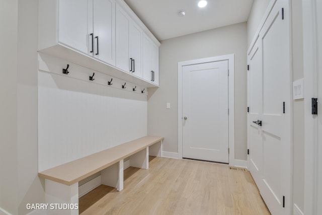 mudroom featuring baseboards and light wood finished floors