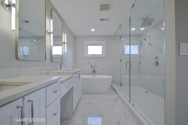full bathroom featuring a marble finish shower, a sink, double vanity, tile walls, and marble finish floor