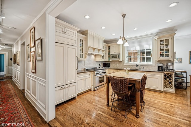 kitchen featuring wooden counters, stainless steel appliances, light wood-type flooring, and ornamental molding