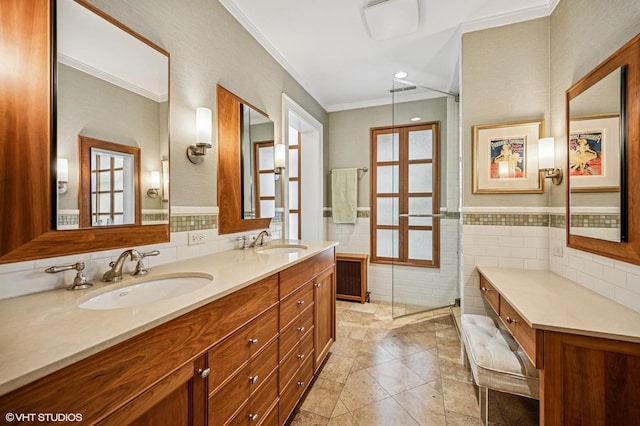 bathroom with double vanity, tile walls, crown molding, and a sink