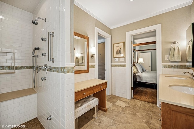 bathroom featuring a sink, tile walls, double vanity, and a walk in shower