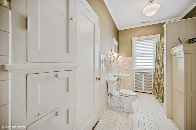 full bathroom with tile patterned flooring, tile walls, toilet, visible vents, and crown molding