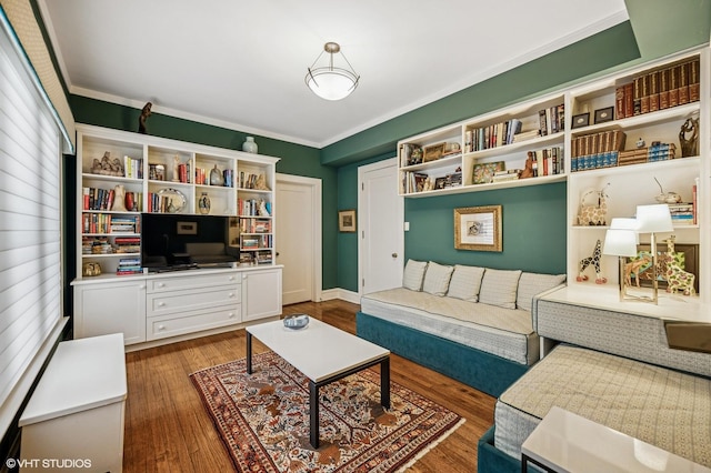 living room with wood finished floors and ornamental molding