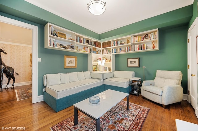 living area with wood finished floors and baseboards