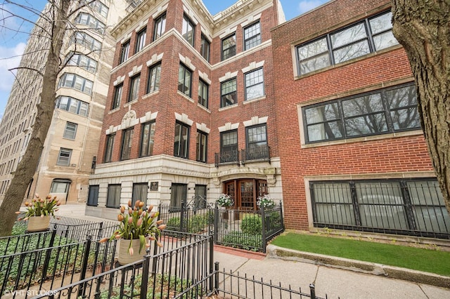 view of building exterior with a fenced front yard