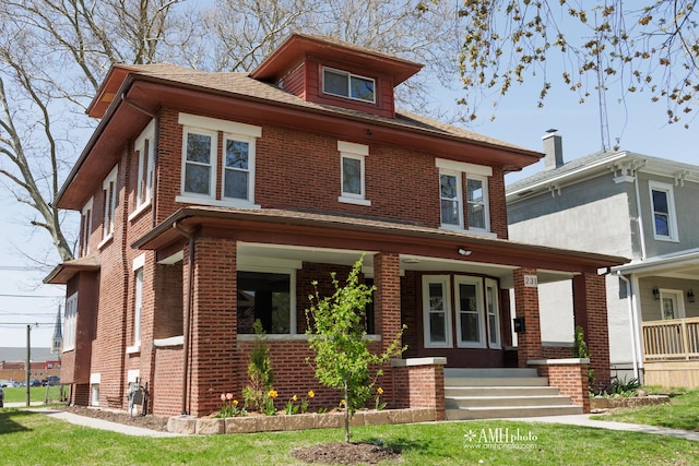 231 S Chicago Ave, Kankakee, IL 60901 - american foursquare style home with brick siding and a porch