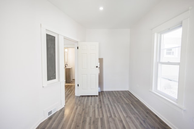 231 S Chicago Ave, Kankakee, IL 60901 - empty room with baseboards, wood finished floors, visible vents, and a wealth of natural light