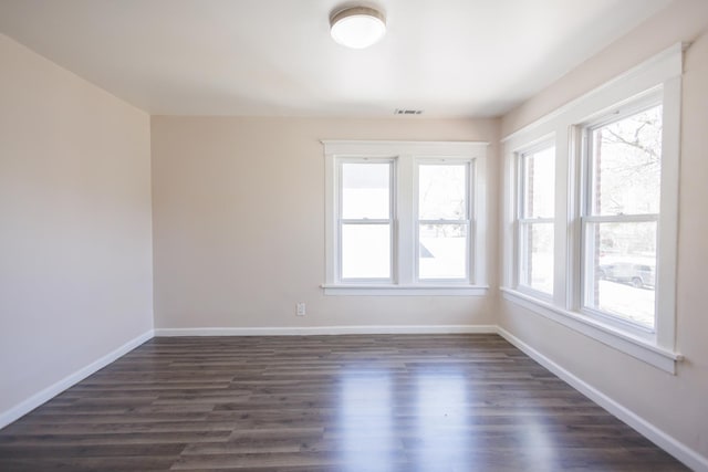 231 S Chicago Ave, Kankakee, IL 60901 - unfurnished room with baseboards and dark wood-style flooring