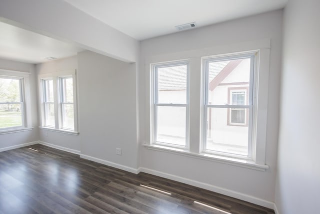 231 S Chicago Ave, Kankakee, IL 60901 - unfurnished room featuring baseboards, dark wood-type flooring, and visible vents