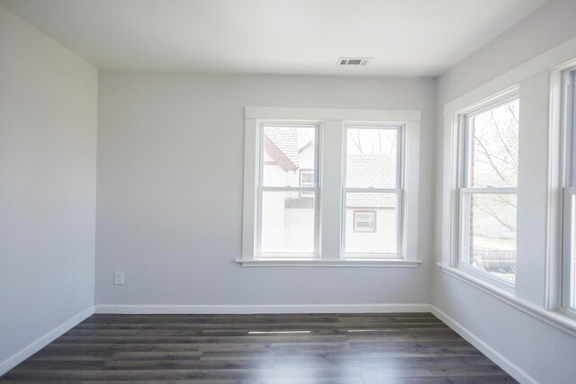 231 S Chicago Ave, Kankakee, IL 60901 - unfurnished room featuring a wealth of natural light, dark wood-type flooring, and visible vents