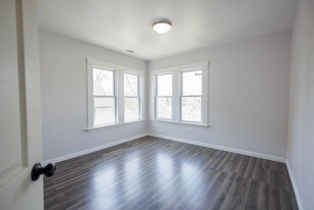 231 S Chicago Ave, Kankakee, IL 60901 - spare room featuring visible vents, baseboards, and dark wood-style floors