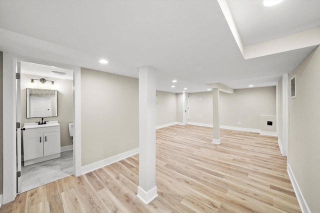 finished basement featuring recessed lighting, baseboards, visible vents, and light wood-style floors