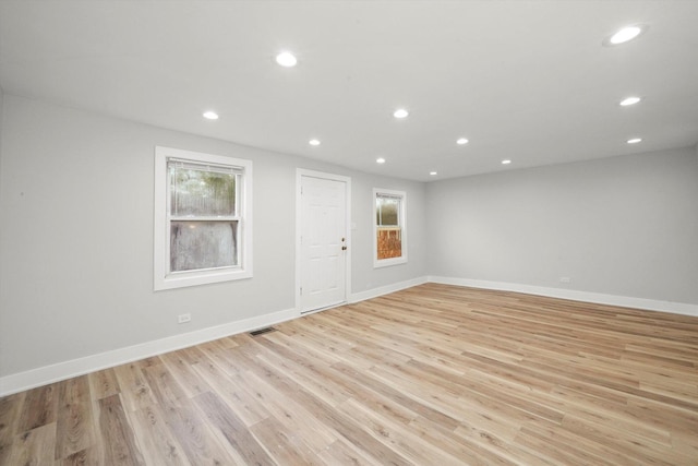 empty room featuring baseboards, recessed lighting, and light wood-style flooring