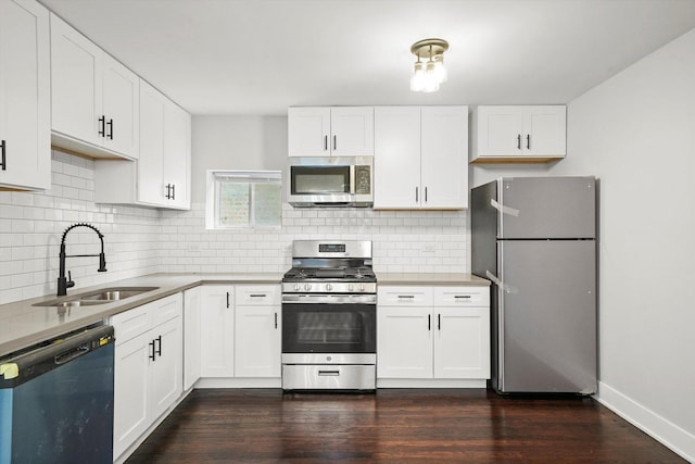 kitchen featuring a sink, white cabinetry, appliances with stainless steel finishes, and tasteful backsplash