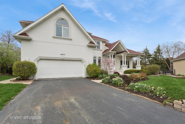 2407 Shaker Ct, Naperville, IL 60564 - traditional-style house with an attached garage, driveway, a front yard, and stucco siding