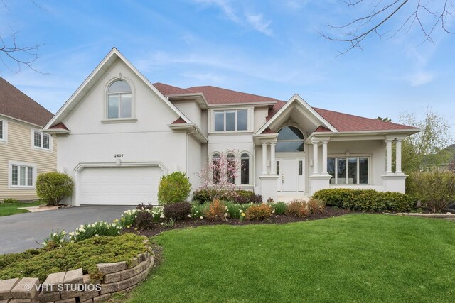 2407 Shaker Ct, Naperville, IL 60564 - view of front of property with an attached garage, a front lawn, driveway, and stucco siding