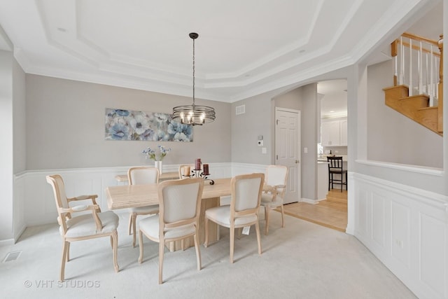 2407 Shaker Ct, Naperville, IL 60564 - dining area featuring a wainscoted wall, a tray ceiling, visible vents, arched walkways, and stairs