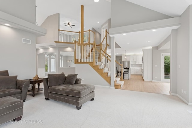 2407 Shaker Ct, Naperville, IL 60564 - living area featuring high vaulted ceiling, visible vents, a ceiling fan, and light colored carpet