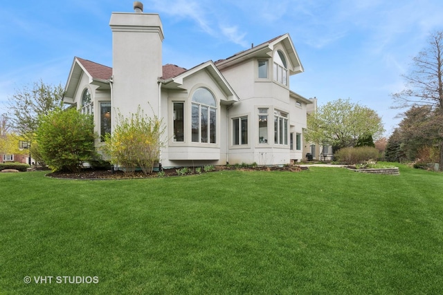 2407 Shaker Ct, Naperville, IL 60564 - back of house with a lawn, a chimney, and stucco siding