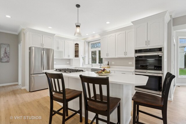 2407 Shaker Ct, Naperville, IL 60564 - kitchen featuring white cabinets, light wood finished floors, stainless steel appliances, light countertops, and ornamental molding
