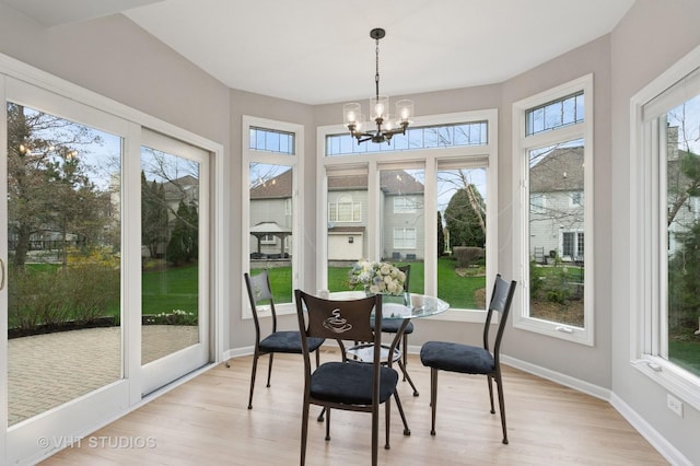 2407 Shaker Ct, Naperville, IL 60564 - sunroom featuring wood finished floors, baseboards, and an inviting chandelier