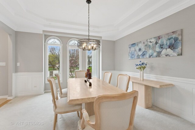 2407 Shaker Ct, Naperville, IL 60564 - dining space featuring light carpet, a wainscoted wall, a tray ceiling, an inviting chandelier, and crown molding