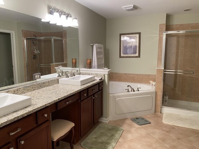 full bath featuring a shower stall, tile patterned floors, a sink, a bath, and double vanity
