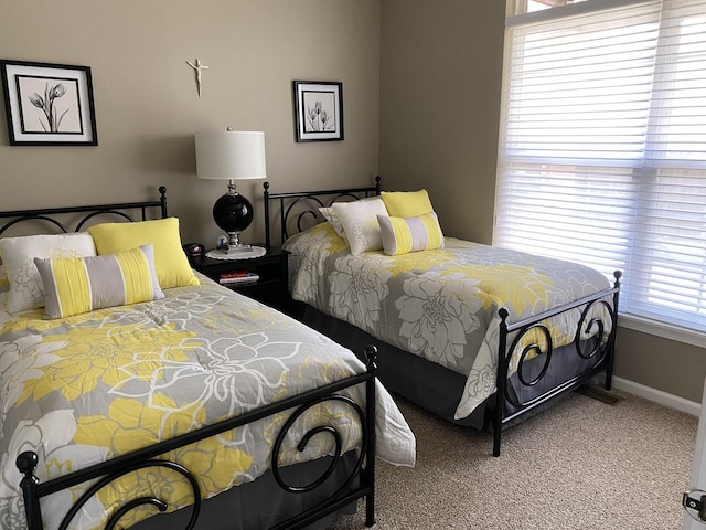 bedroom featuring carpet flooring and baseboards