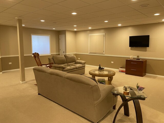 living area featuring baseboards, recessed lighting, and light colored carpet