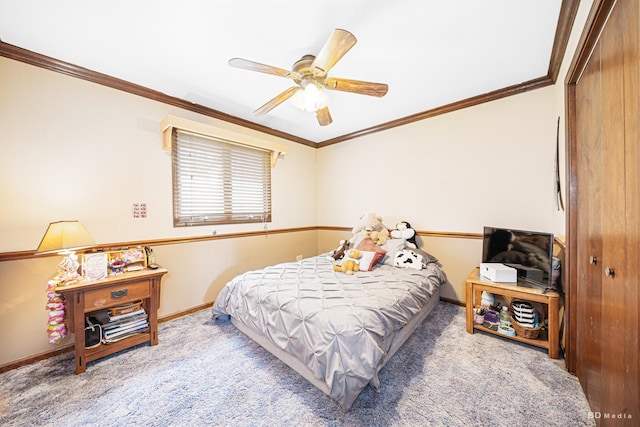 carpeted bedroom featuring baseboards, ornamental molding, and a ceiling fan