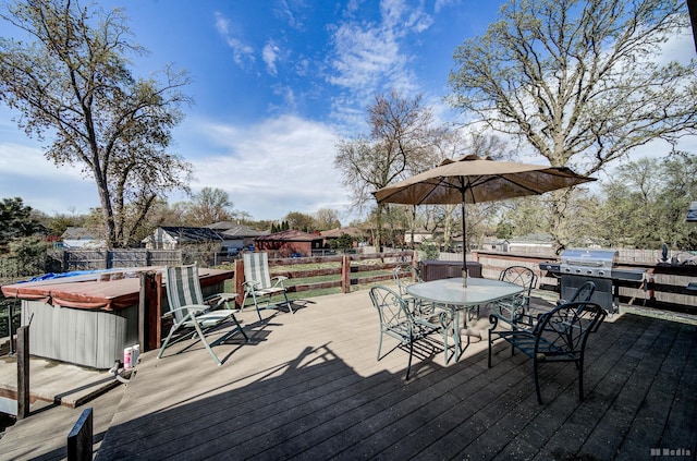 wooden terrace with a hot tub, outdoor dining area, a fenced backyard, and a grill