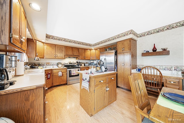 kitchen featuring a center island, light countertops, a sink, and stainless steel appliances