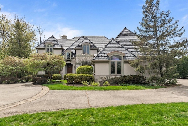 1784 Reserve Ct, Highland Park, IL 60035 - french country style house with stucco siding, a chimney, and stone siding