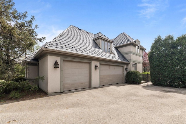1784 Reserve Ct, Highland Park, IL 60035 - view of front of home with stucco siding, driveway, and an attached garage